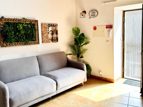 a living room with a couch and a plant at Casa São Sebastião - Casas BemHaja in São Miguel de Acha