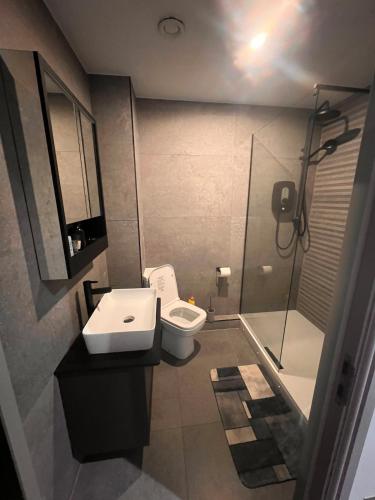 a bathroom with a shower and a toilet and a sink at The Jesmond Hideaway - Cosy Modern Apartment in Jesmond