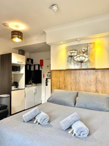 a bedroom with a bed with towels on it at Riverside Hotel in Norwich
