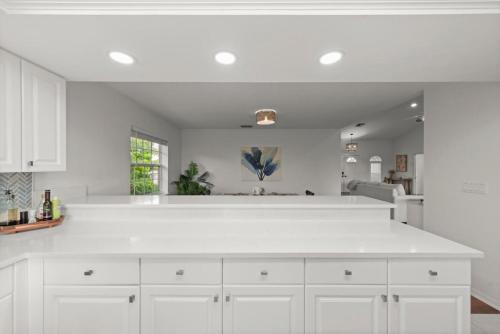 a white kitchen with a large white counter top at Casa Al Mare in Sanibel Island
