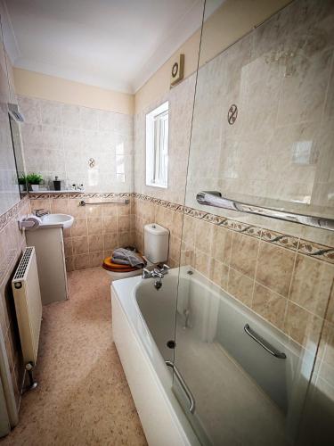 a bathroom with a tub and a sink at Viking Guest House in Bridlington