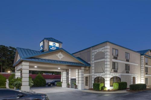 a hotel with a clock tower on top of it at Best Western Executive Inn & Suites in Columbia