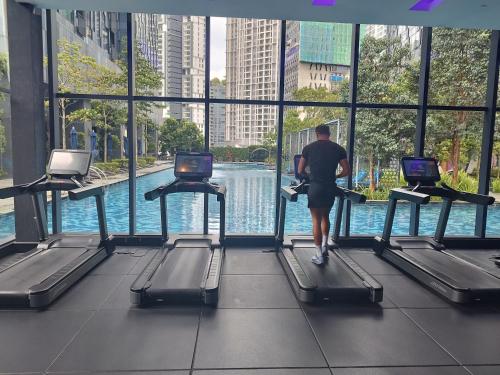 a man walking on treadmills in a large building at Casaluma STAR KLCC in Kuala Lumpur