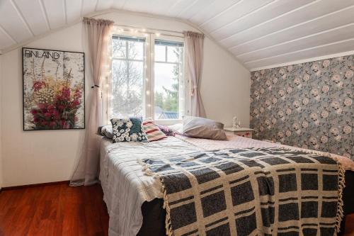 a bedroom with a bed and a window at Santa's closest neighbor in Rovaniemi