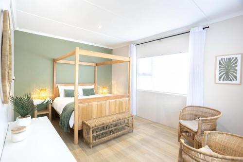 a bedroom with a canopy bed and a table and chairs at Hilton House One in Hilton