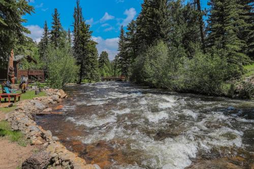 a river with rapids in the middle at Idlewilde by the River in Estes Park