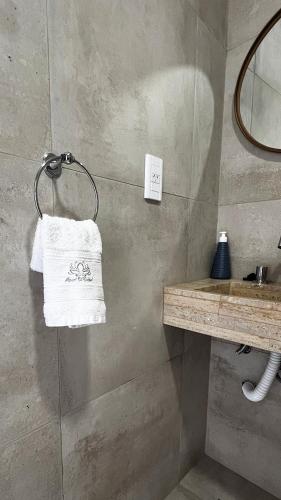 a bathroom with a towel hanging on a wall at Carmel Apart Paraná in Paraná