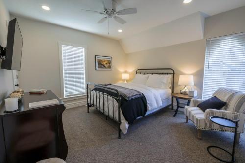 a bedroom with a bed and a couch and a chair at Eliza Gothic in Maquoketa