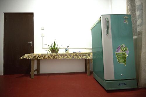 a kitchen with a counter and a refrigerator at New Look villa in Mirissa
