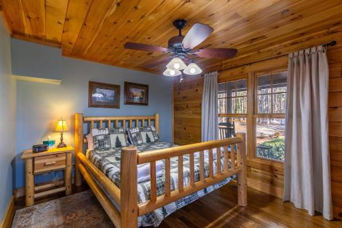 a bedroom with a bed and a ceiling fan at Our Neck of the Woods at Hidden Lake in Nebo