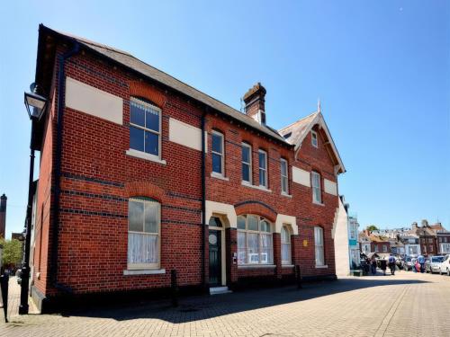 a red brick building on a city street at Mutiny House in Weymouth