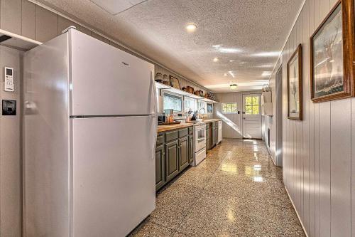 a kitchen with a white refrigerator and green cabinets at Cabin in Nature at Cliffwood Colony in Shirley