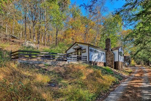 a small building on the side of a dirt road at Cabin in Nature at Cliffwood Colony in Shirley