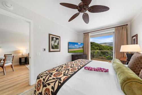 a bedroom with a bed and a couch and a window at Maui Luxury Mountain-View Villa at Honua Kai in Lahaina