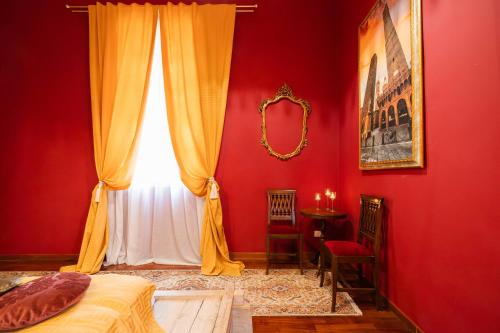 a bedroom with red walls and a window and a bed at Villa Meraville B&B in Bologna