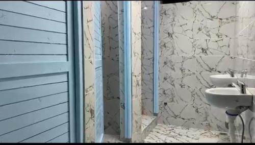 a bathroom with a sink and a shower at منتزه السلامة Parc ASSALAMA in Kenitra