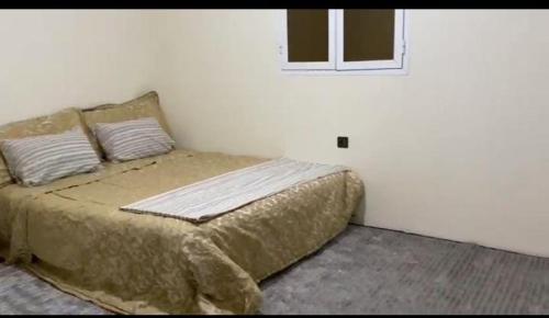 a bedroom with a bed in a white room at منتزه السلامة Parc ASSALAMA in Kenitra