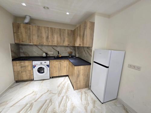 una cocina con nevera y lavadora en Your Yerevan Home, en Ereván