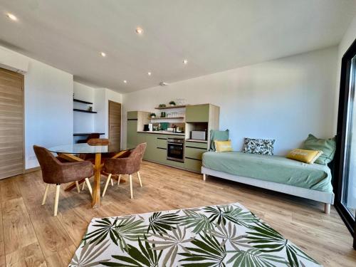 a living room with a couch and a table at Domaine LUMISTELLA 2 in Porticcio