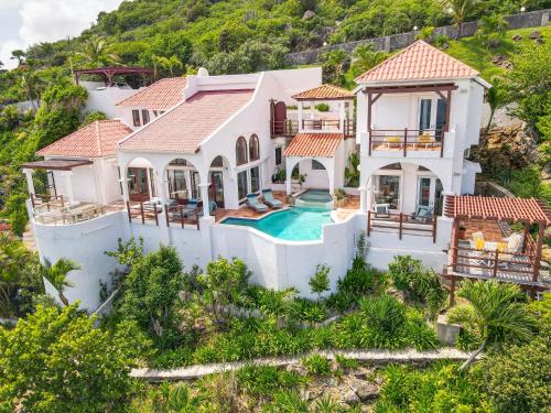 an aerial view of a villa with a swimming pool at Villa Leones Breathtaking Views and Authentic Charm in Oyster Pond