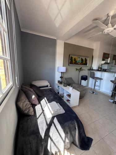 a living room with a bed and a couch at Temporario Mitre in Vuelta del Paraguayo
