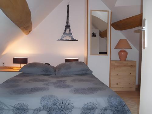 a bedroom with a bed with the eiffel tower at Gîte Mélany in Chargé