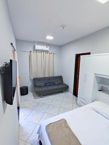 a bedroom with a bed and a couch in it at Casa Studio"' São José dos Campos in São José dos Campos
