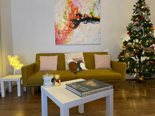 a living room with a christmas tree and a couch at Amazing Location with Parking in Kent