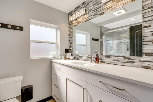 a white bathroom with a sink and a mirror at Great Outdoor Space! Family Home in SLC Suburbs in Midvale