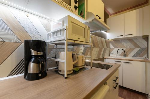 a kitchen with a coffee maker on a counter at Mini-studio à 2 petits pas in Bagnères-de-Bigorre
