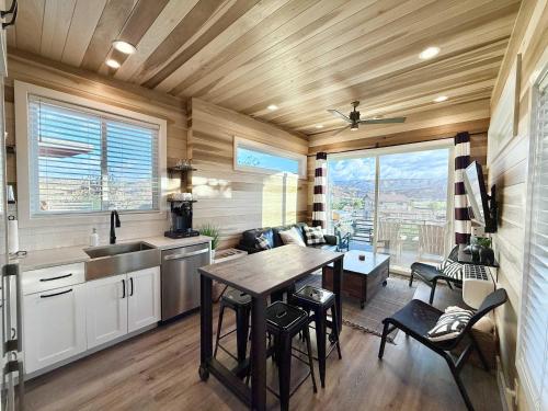 a kitchen and living room with a table and chairs at Escalante Escapes Tumble Weed- Bunk Escape in Escalante