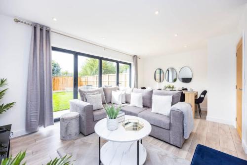 een woonkamer met een bank en een tafel bij New 3 Bed House, Sittingbourne, Sleeps 7, Contractors, Families , Weekly and Monthly Offers in Milton Regis