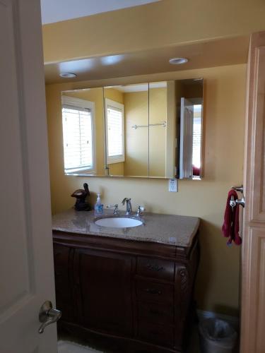 a bathroom with a sink and a mirror at Capitola Pelican House in Capitola