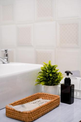 a bathroom counter with a soap dispenser and a sink at Sarana Guest House in Luang Prabang