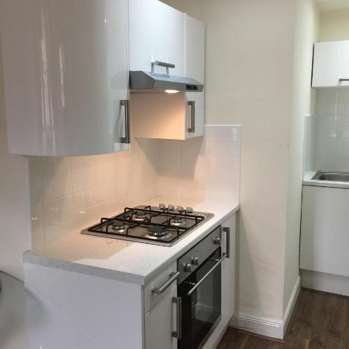 a kitchen with a stove and a white counter top at Trefoil Apartment - 2 Bedrooms in Glasgow
