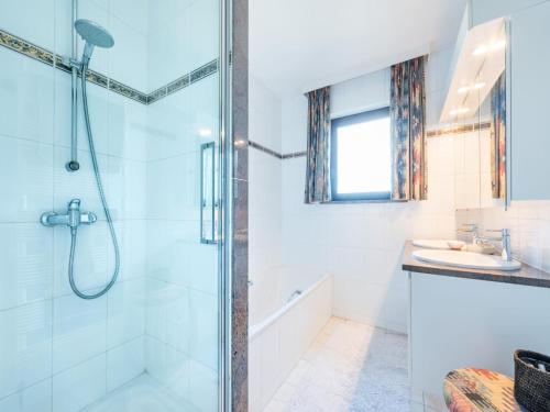 a bathroom with a shower and a sink at Aubépine premier in Sint-Idesbald