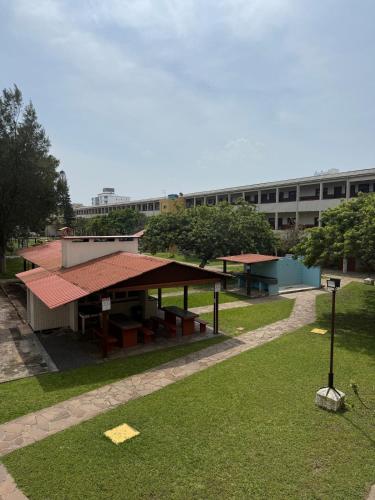 a building with a pavilion in the middle of a park at Apartamento pé na areia em Tramandaí in Tramandaí