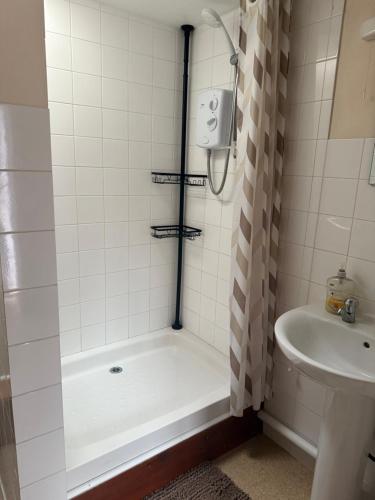 a bathroom with a shower and a sink at Holly cottage in Catfield