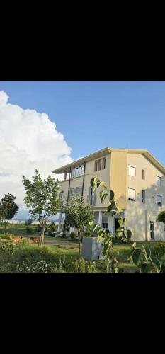 a large building with trees in front of it at libaLAGUNA in Velipojë