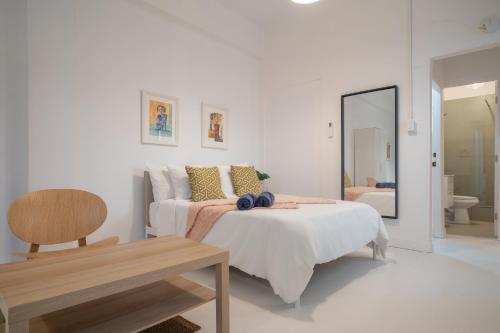 a bedroom with a bed and a table and a mirror at Luma Boutique Collection by PH in San Juan