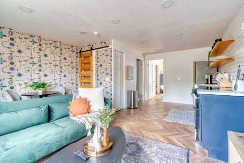 a living room with a blue couch and a kitchen at Stay Portland - The Woodstock Inn - Reed College & Vintage Shops in Portland