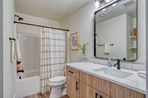 a bathroom with a sink and a toilet and a mirror at Stay Portland - The Madison Farmhouse - Vintage Shops & Espresso in Portland