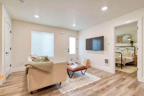 a living room with a couch and a tv at Stay Portland - The Madison Farmhouse - Vintage Shops & Espresso in Portland