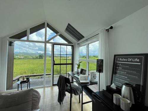 a living room with a large window with a view at Lalaland CD in Ban Mae Khon