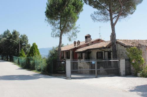 a house with a gate in front of it at Società Agricola F.lli Angelucci in Cannara