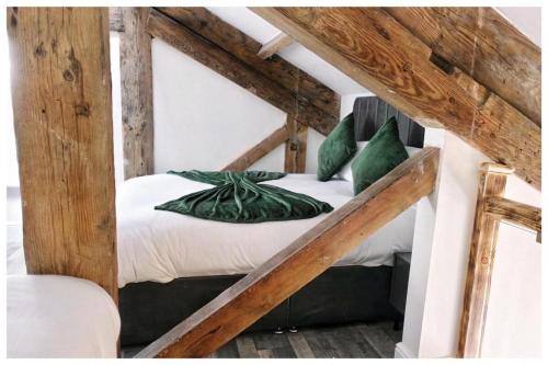 a bed with green pillows in a room at 1Bed Apt- Sleeps 6 City Center Jacuzzi Bath Wifi in Bradford