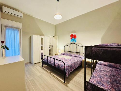 a bedroom with two bunk beds and a window at Angelia in Capaci