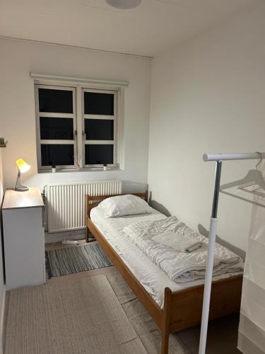 a bedroom with a bed and a window at AWCompany Aps WORK & STAY-North Zealand Crew Accommodation in Tisvildeleje