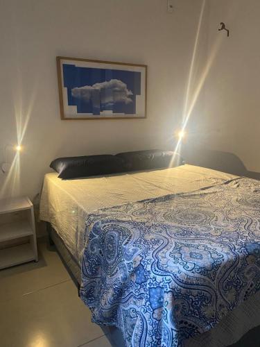 a bedroom with a bed with two lights on it at Sol Nascente Apartamento in Ilhéus