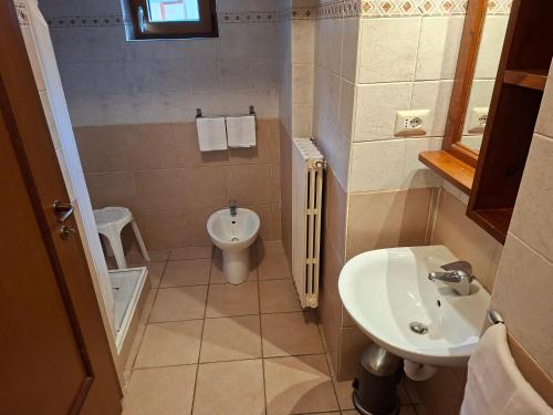 a small bathroom with a sink and a toilet at Residence Les Lacs in Bardonecchia